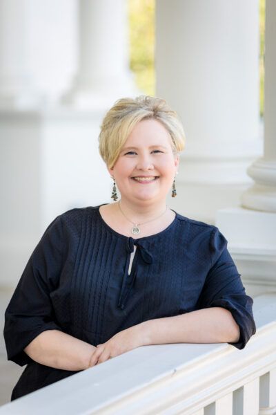 Ashley Weems. White woman with short blonde hair wearing a navy blouse.