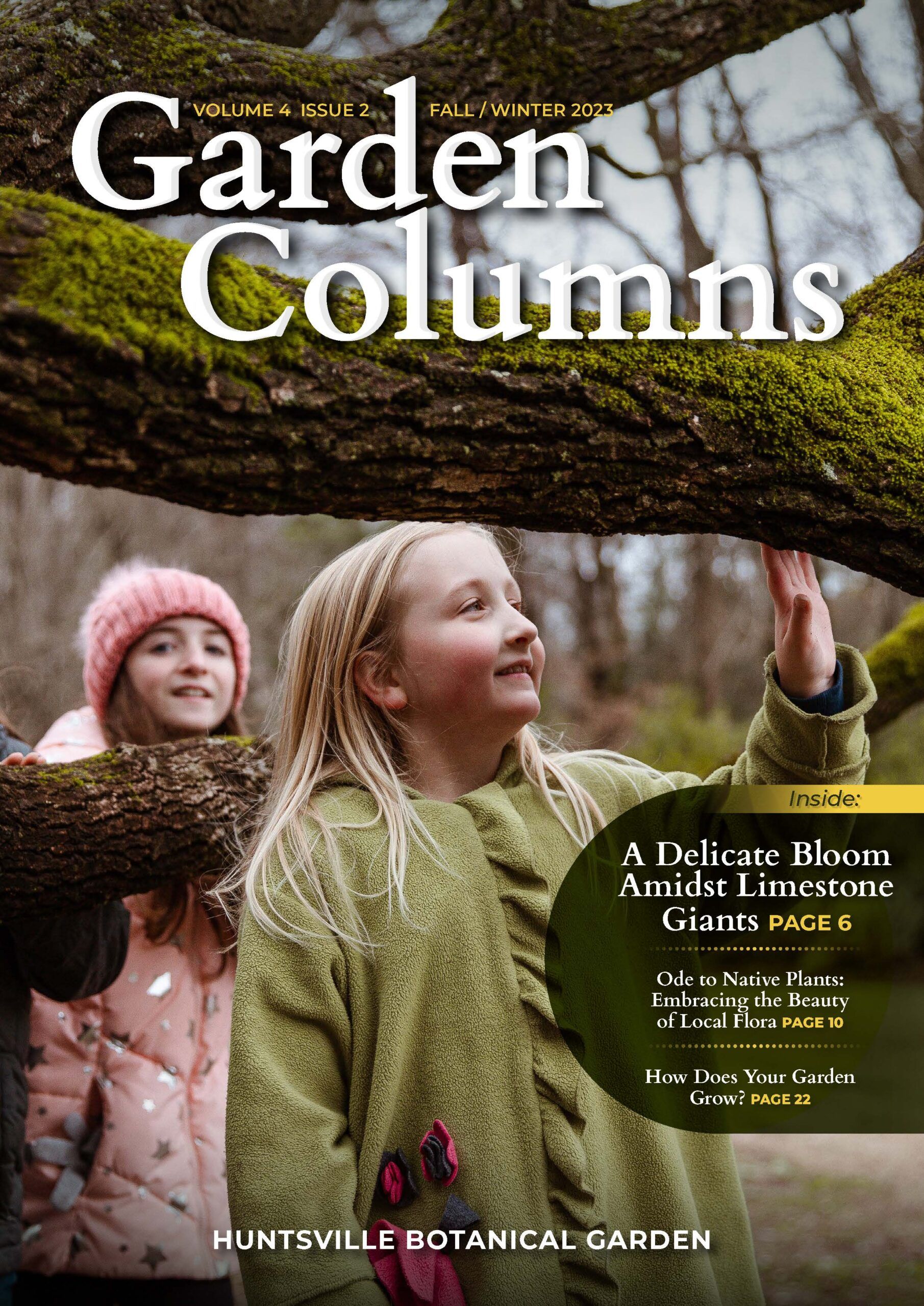 Magazine cover with two young girls touching moss on a tree