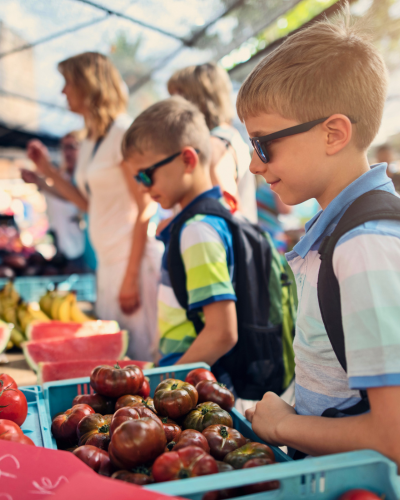Two young boys shop at Farmers' Market